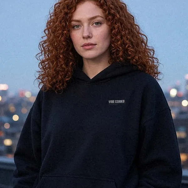AI-generated render of the Vibe Coded. Shipped Anyway. Hoodie in Black on a model, front view: small left-chest print reading VIBE CODED.
